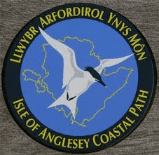 This image has an empty alt attribute; its file name is Anglesey-Coast-Path-Sign.png